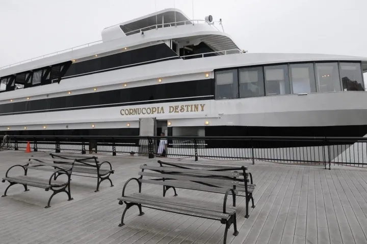 a group of people sitting at a dock