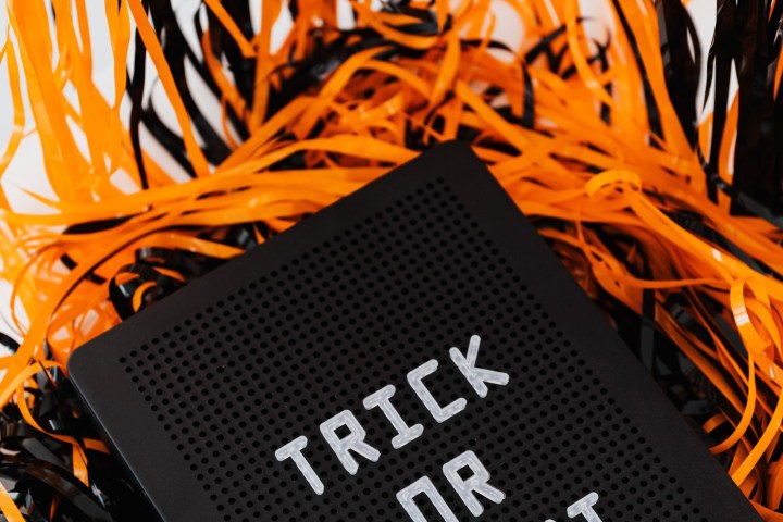 Sign with 'Trick or Treat' amid orange and black streamers.